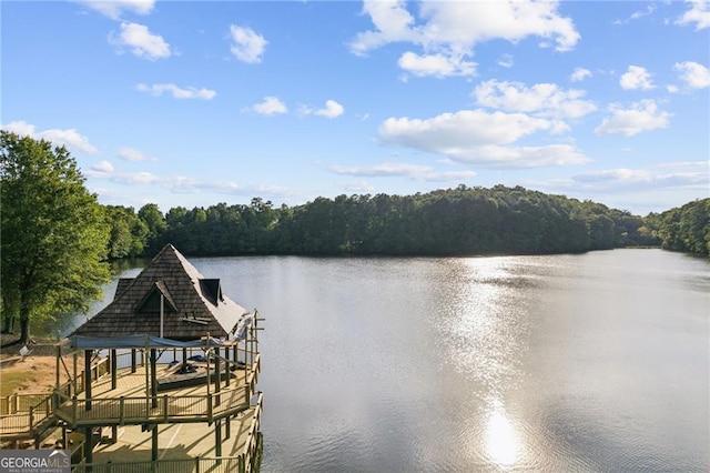 dock area featuring a water view and a wooded view