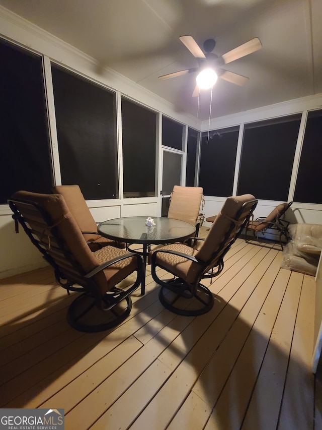 wooden terrace featuring ceiling fan and outdoor dining area