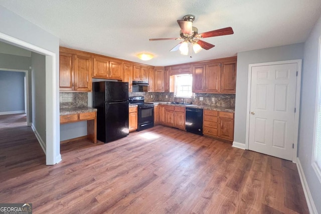 kitchen featuring ceiling fan, dark hardwood / wood-style flooring, black appliances, and backsplash