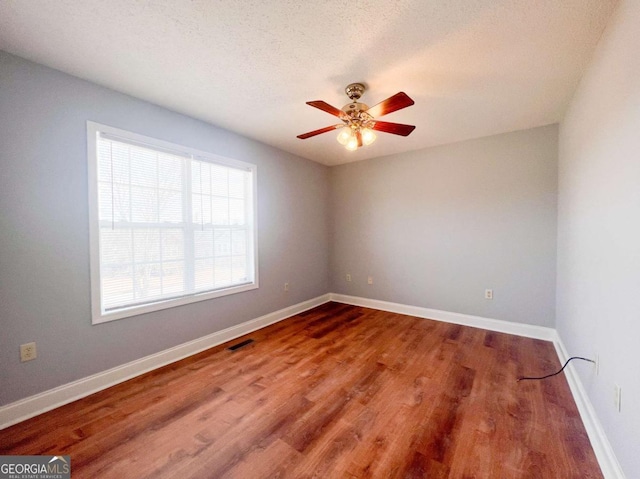 unfurnished room featuring ceiling fan, a textured ceiling, and hardwood / wood-style floors