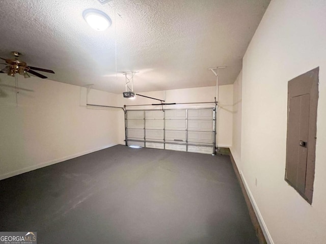 garage with electric panel, ceiling fan, and a garage door opener