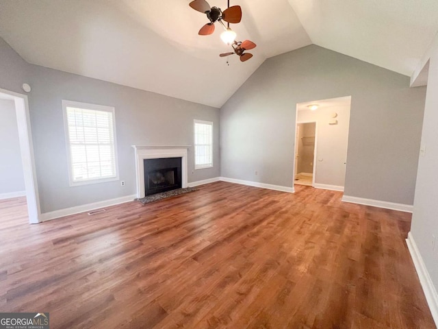 unfurnished living room with vaulted ceiling, hardwood / wood-style floors, and ceiling fan