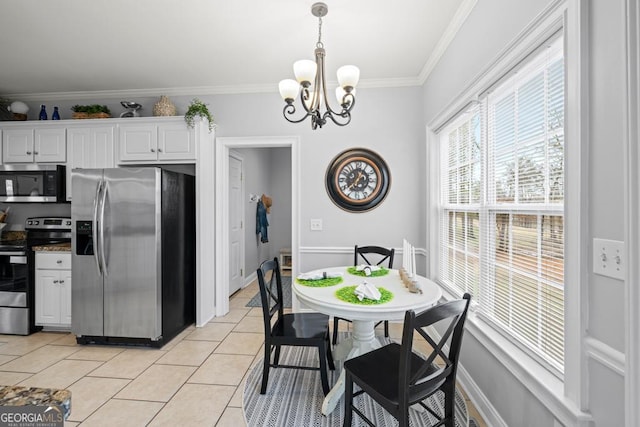 kitchen with ornamental molding, hanging light fixtures, white cabinetry, stainless steel appliances, and light tile patterned flooring