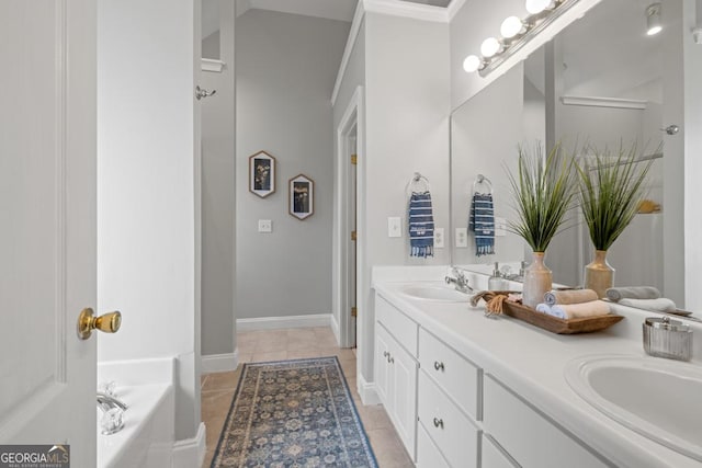 full bathroom with baseboards, a sink, a tub, tile patterned flooring, and double vanity