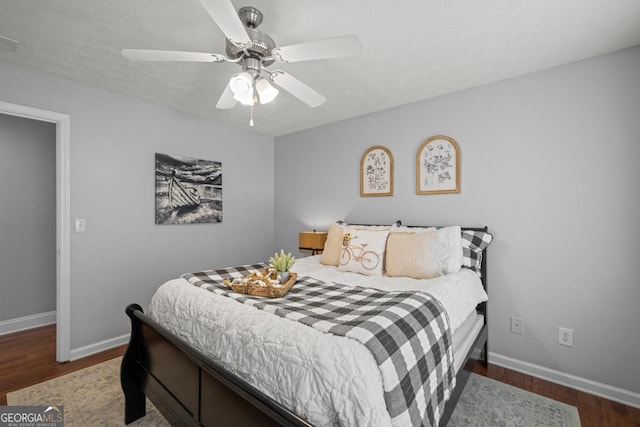 bedroom with dark wood-style flooring, baseboards, a ceiling fan, and visible vents