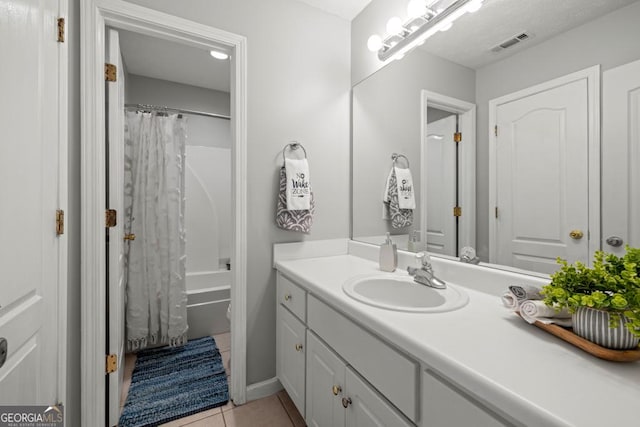 full bathroom featuring visible vents, vanity, tile patterned floors, and shower / bathtub combination with curtain