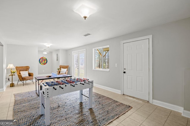 rec room with visible vents, light tile patterned floors, baseboards, and french doors