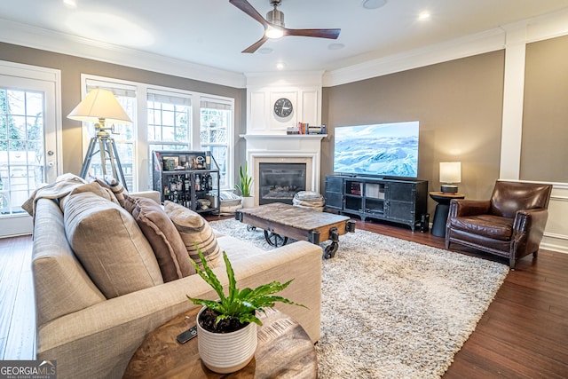 living room with crown molding and plenty of natural light