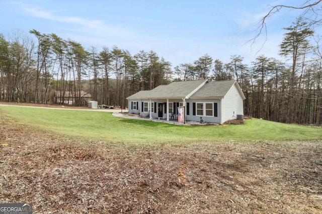 view of front of house with a front yard and central AC unit