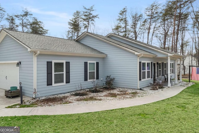 view of side of home featuring a garage and a lawn