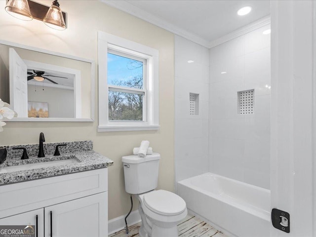 full bathroom featuring toilet, vanity, tiled shower / bath, and crown molding