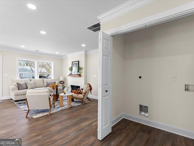 living room featuring dark hardwood / wood-style flooring and ornamental molding