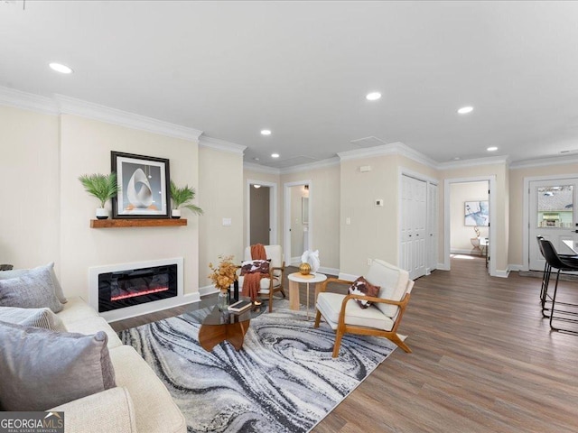 living room featuring hardwood / wood-style flooring and ornamental molding