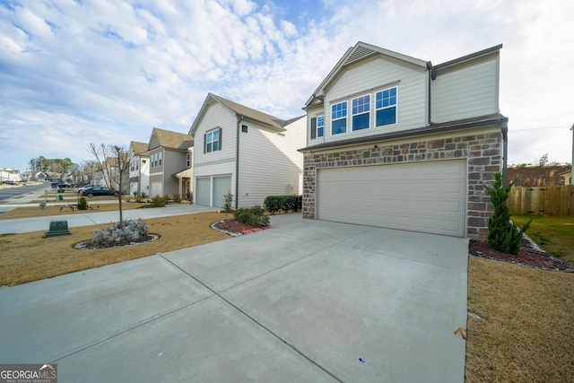 view of property featuring a garage and a front yard