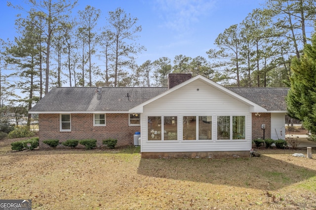 rear view of house with a lawn