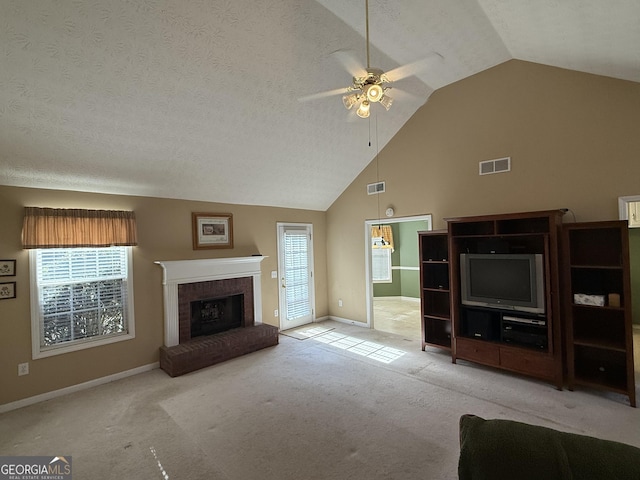 unfurnished living room featuring visible vents, plenty of natural light, and carpet flooring