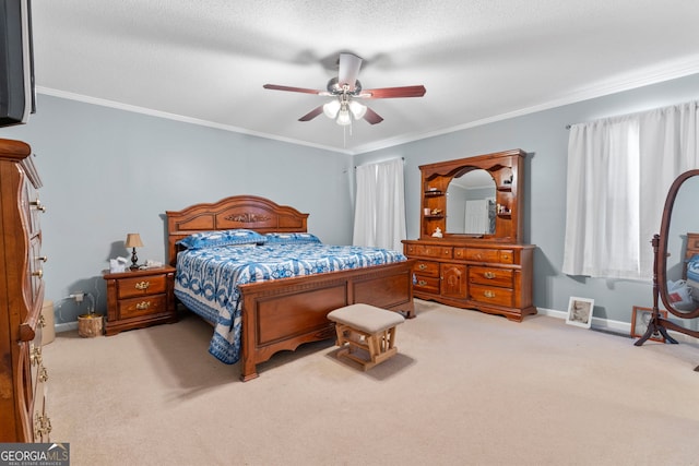 carpeted bedroom with a textured ceiling, ceiling fan, and ornamental molding