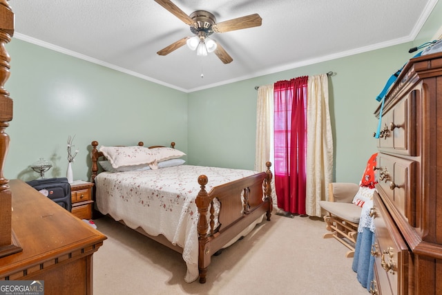 bedroom with a textured ceiling, ornamental molding, light colored carpet, and ceiling fan