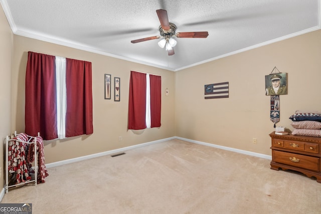 interior space with ceiling fan, crown molding, a textured ceiling, and light colored carpet