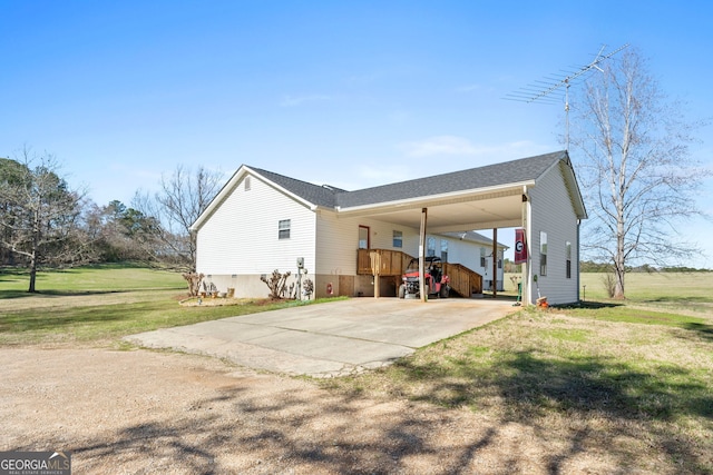 view of home's exterior featuring a yard and a carport