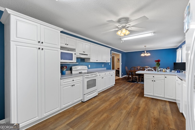 kitchen with white appliances, white cabinetry, pendant lighting, and kitchen peninsula