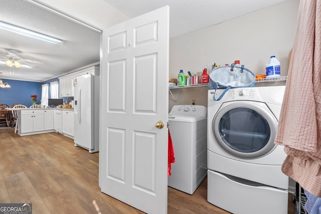 laundry room featuring ceiling fan, washing machine and clothes dryer, and light hardwood / wood-style floors