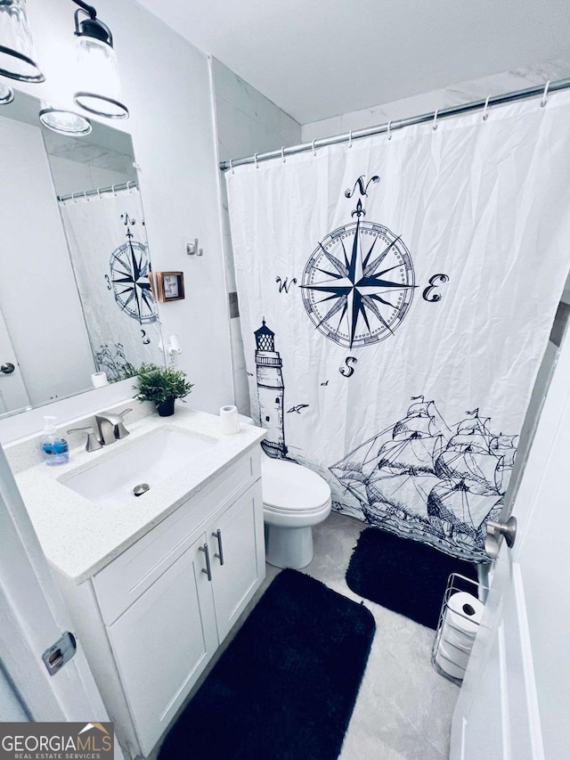 bathroom with toilet and vanity