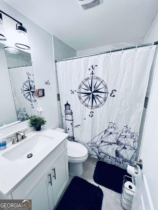 bathroom with toilet and vanity