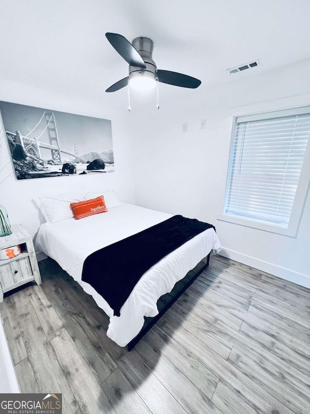 bedroom with ceiling fan and hardwood / wood-style floors