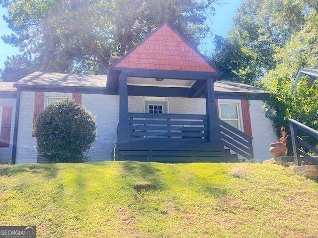 view of home's exterior featuring a deck and a lawn