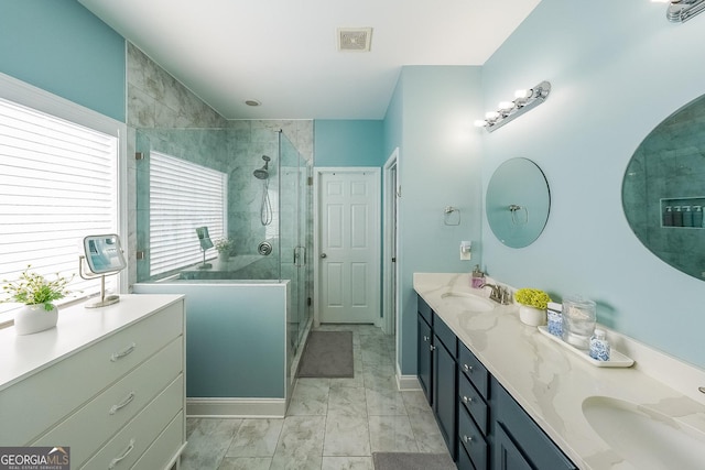 bathroom featuring vanity and an enclosed shower