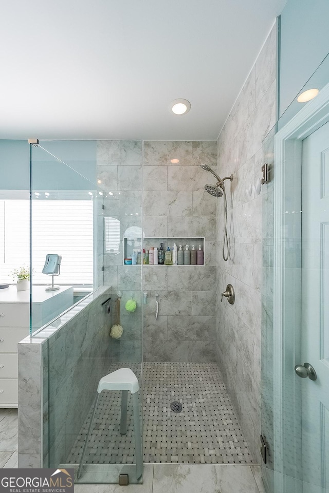 bathroom with a shower with shower door