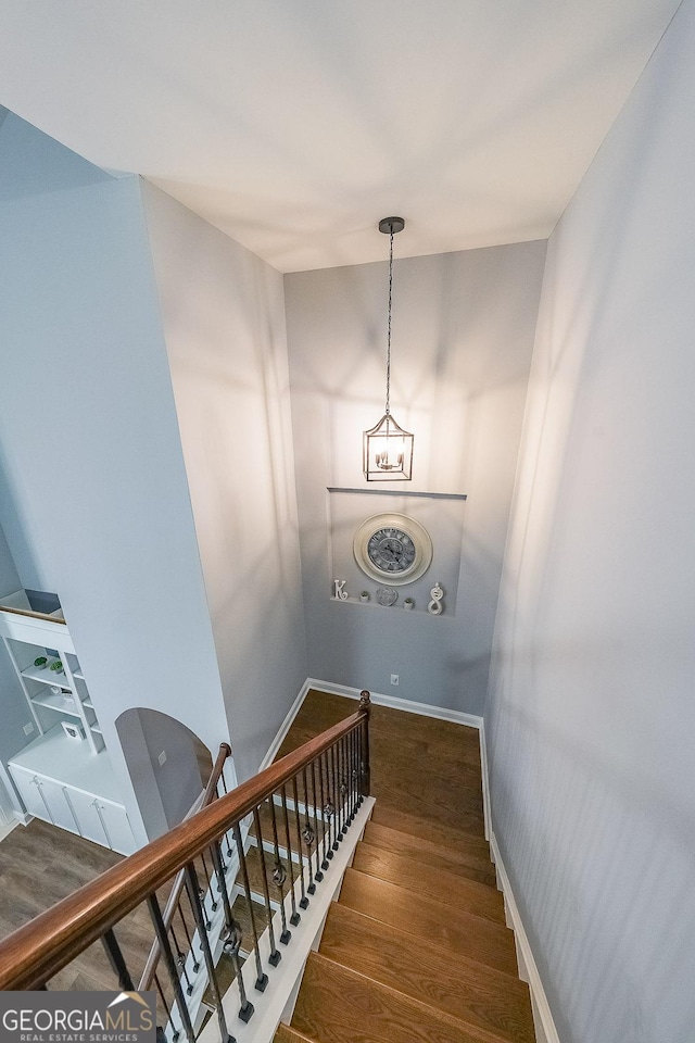 staircase with hardwood / wood-style floors