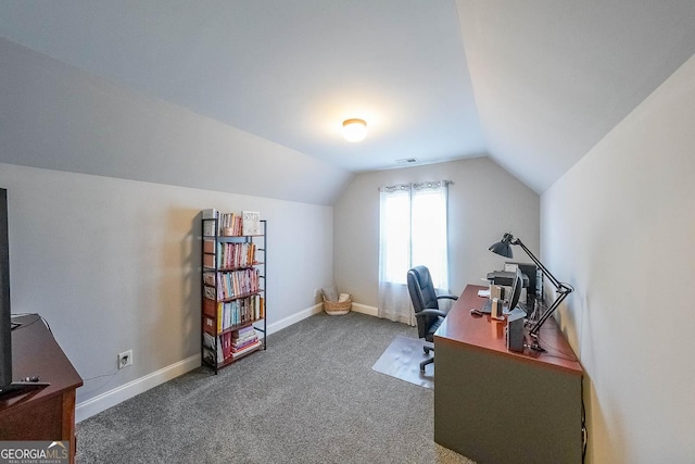 home office featuring dark carpet and vaulted ceiling