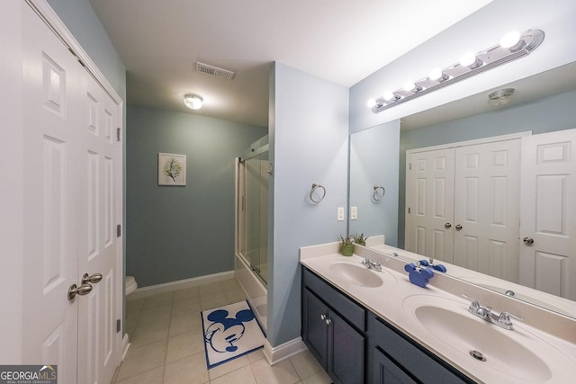 full bathroom featuring tile patterned floors, toilet, vanity, and enclosed tub / shower combo