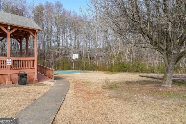 view of yard with basketball court