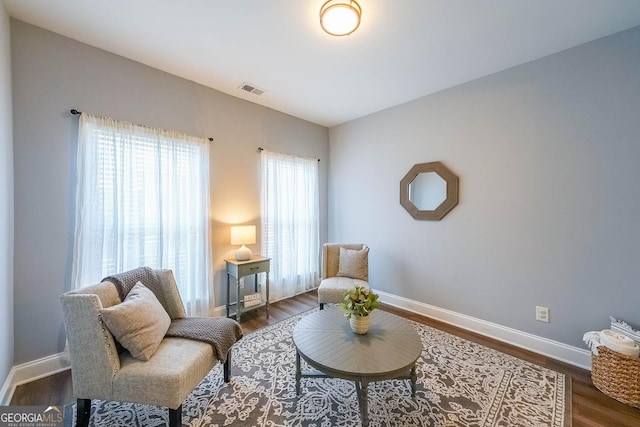 living area with dark hardwood / wood-style floors