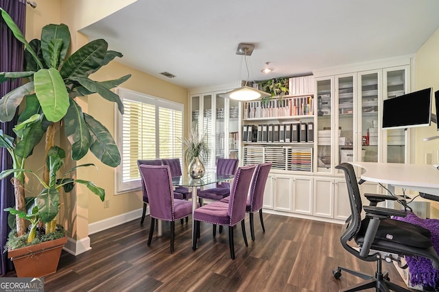 dining room featuring baseboards, visible vents, and dark wood-style flooring