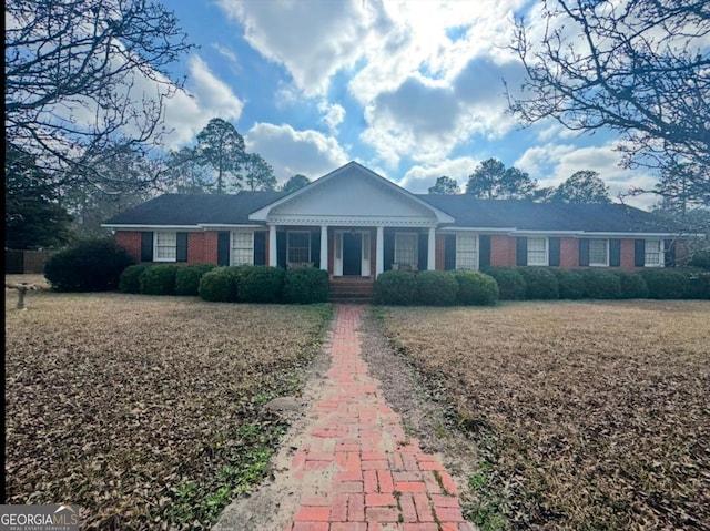 ranch-style house with a front lawn