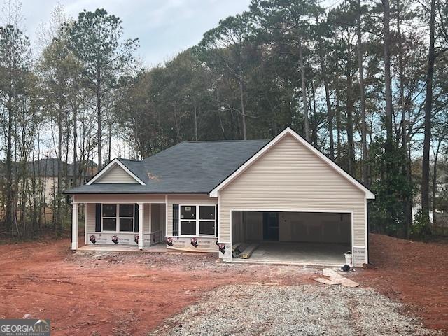 view of front facade with a garage and a porch