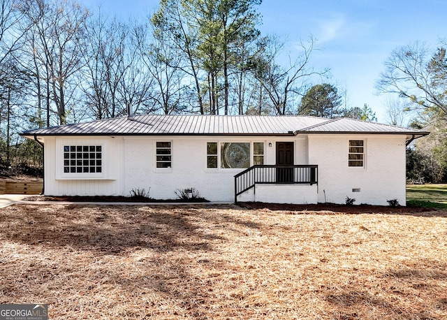 single story home with crawl space, metal roof, and brick siding