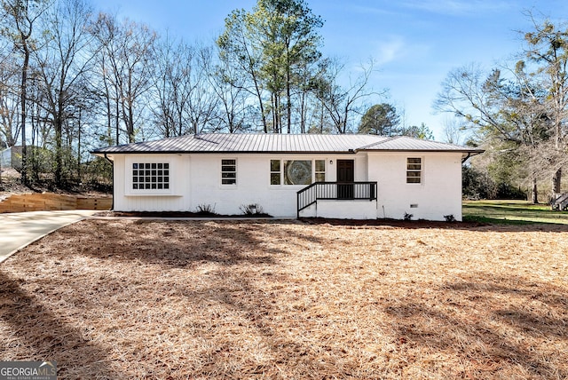 ranch-style house with crawl space, brick siding, and metal roof