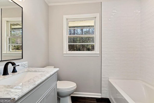 full bath featuring toilet, wood finished floors, vanity, baseboards, and crown molding