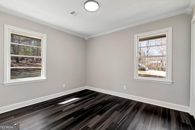 empty room featuring crown molding, dark wood finished floors, visible vents, and baseboards