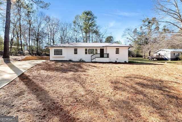 ranch-style house with metal roof