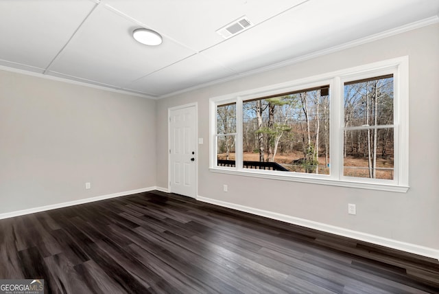 interior space with ornamental molding, dark wood-style flooring, visible vents, and baseboards