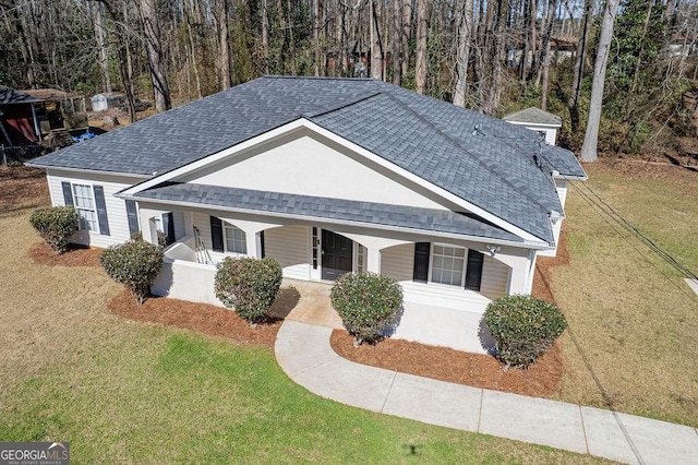 view of front of property featuring covered porch and a front yard