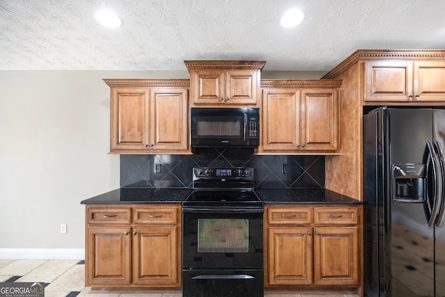 kitchen featuring decorative backsplash, dark stone counters, a textured ceiling, and black appliances