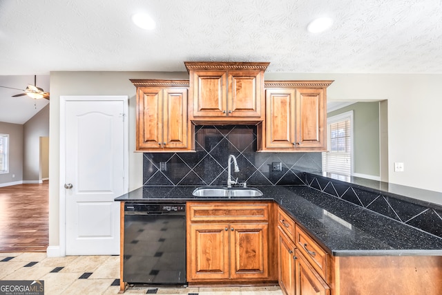 kitchen featuring sink, tasteful backsplash, ceiling fan, dishwasher, and dark stone countertops