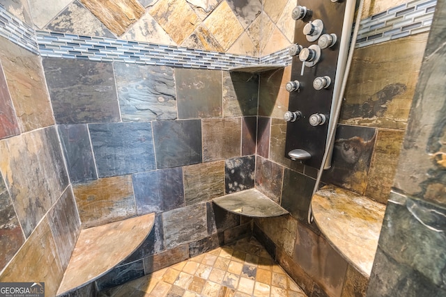 bathroom with a tile shower